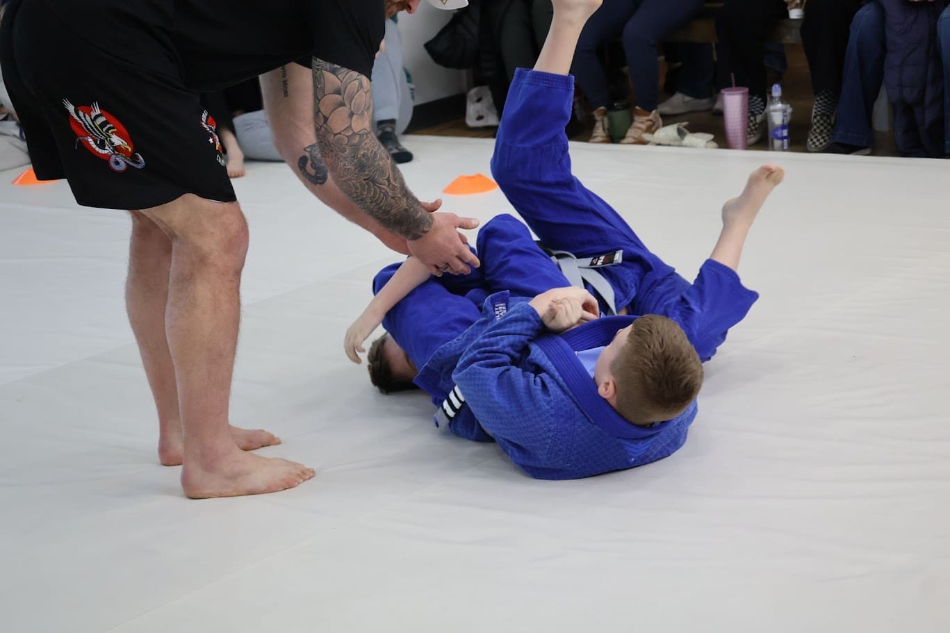 Teens attending martial arts classes, guided by instructors, learn self-defense skills, physical and mental skills, goal setting, and the benefits of practicing respect, eventually earning a black belt to defend themselves in various situations.