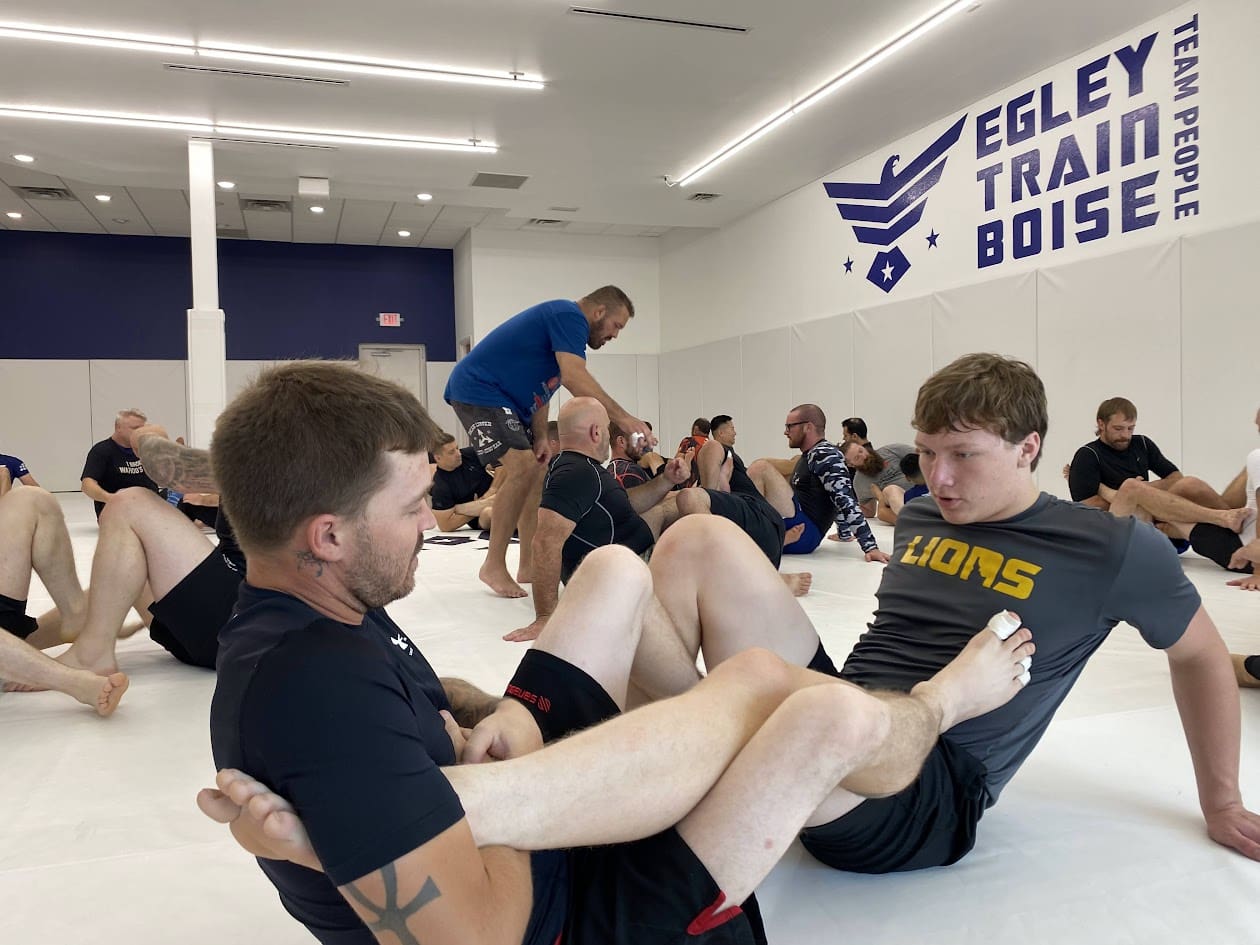 Teens practicing Brazilian Jiu-Jitsu (BJJ), a martial art rooted in the Gracie family tradition, benefit from a supportive community of training partners that fosters self-confidence, stress relief, goal setting, and personal growth as they face challenges on the path to earning a black belt.