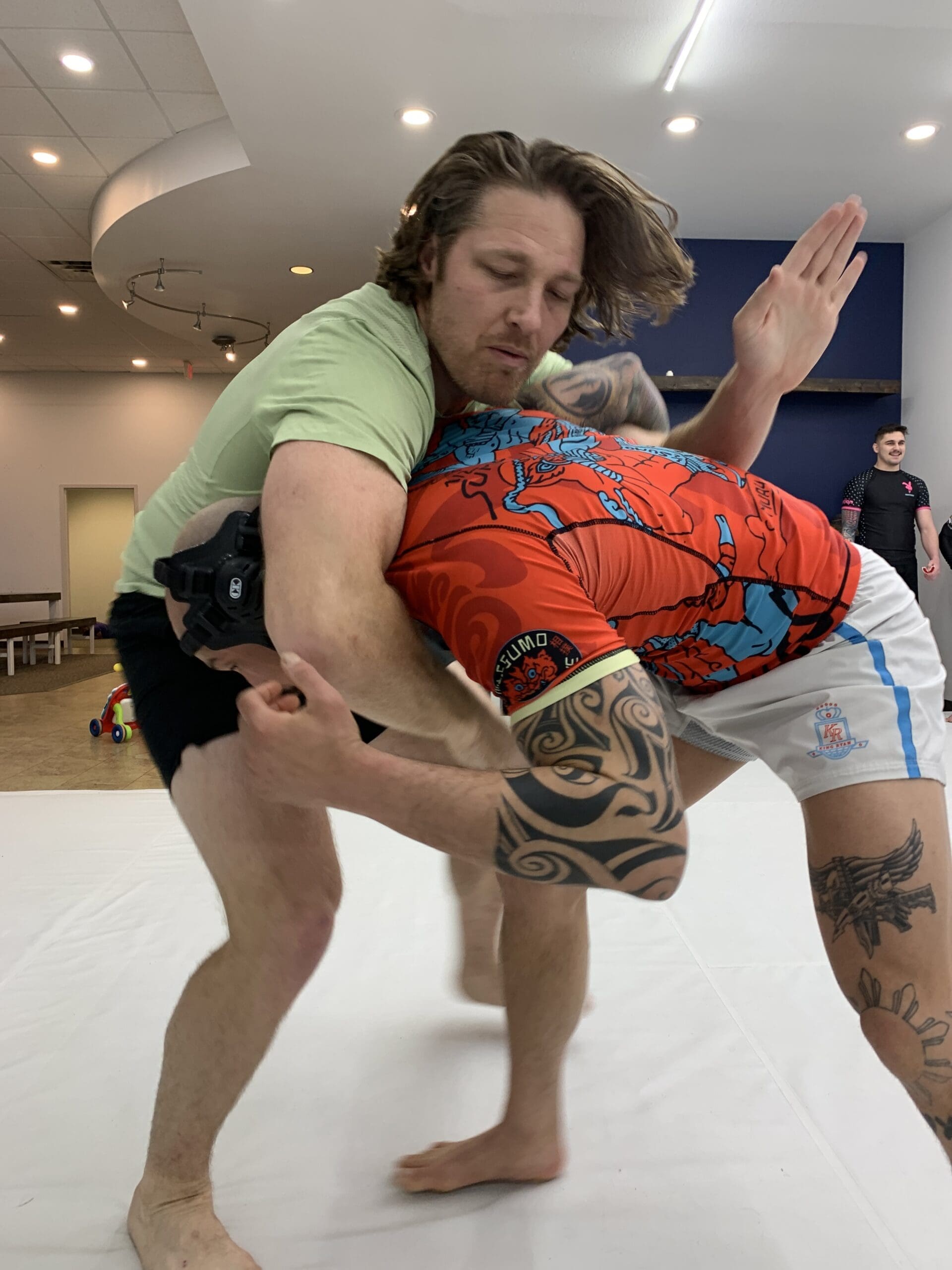 American Jiu-Jitsu training partners working a takedown with clean, controlled technique at Egley Train Academy in Boise
